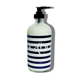 FORK & MELON clean luxury lotion with dark navy and white stripe bottle design