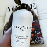 large luxury organic lotion with flip top cap, in front of Vogue magazine