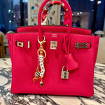 FORK & MELON SOAP AF beaded keychain charm on a bright pink designer Hermes handbag — black and white beaded detail with gold hardware and checkered heart accent, styled as a chic accessory.