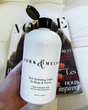 Load image into Gallery viewer, large luxury organic lotion with flip top cap, in front of Vogue magazine