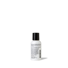 Load image into Gallery viewer, Backside of travel-size black and white hand lotion / body lotion by FORK &amp; MELON