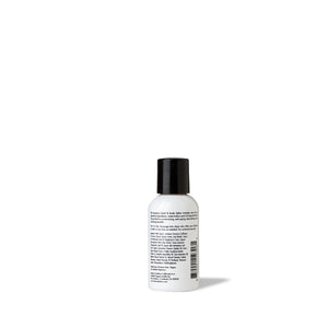Backside of travel-size black and white hand lotion / body lotion by FORK & MELON