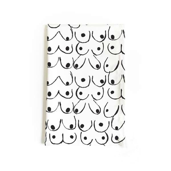 black and white tea towel with art of women's breasts in different shapes and sizes