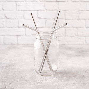 silver reusable straws in glass